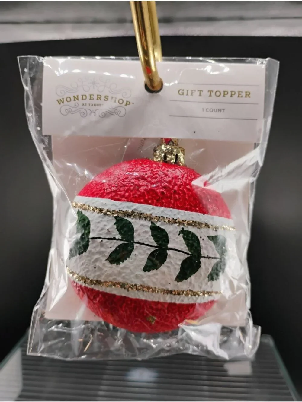 Red & White WonderShop Gift Topper Ornament With Green Leaf Design